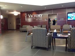 Andrew Hillman. Victory Medical Center lobby with Victory Medical Center Mid Cities wall sign